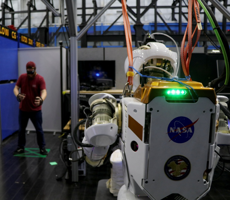 Nasa software engineer Ian Chase controls the humanoid robot Valkyrie with a VR headset and controllers at the Johnson Space Centre in Houston, Texas. Picture: REUTERS/EVAN GARCIA