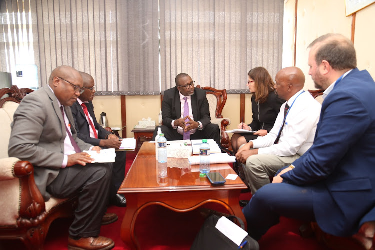 Agriculture CS Mithika Linturi having a chat with development partners led by Ambassador Henriette Geiger, Head of European Union delegation during a consultative meeting at Kilimo House on food security in the country.