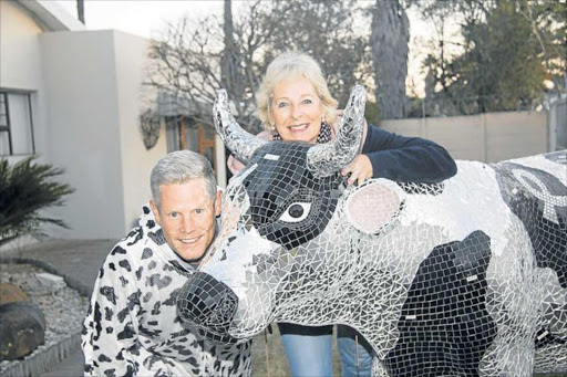 ON THE MOOVE: CHOC Eastern Cape regional manager Debbie Kleinenberg and Durban's Gordon Reid, who has donned a fleecy cow suit to hike the two-day 45km Go-Chi-Mor coastal trail from Gonubie to Morgan Bay this weekend to raise money for the East London CHOC house, which accommodates the out-of-town families of children who undergo cancer treatment in the city Picture: SUPPLIED