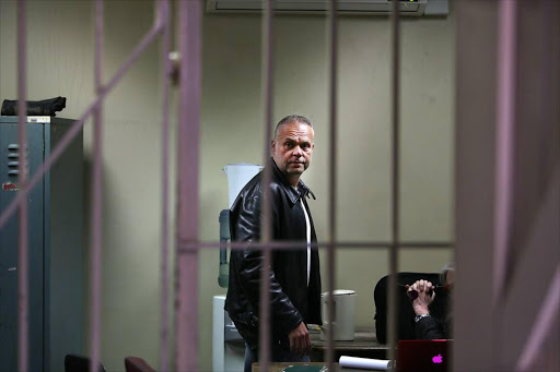 Radovan Krejcir talks to his lawyer in the holding cells ahead of his bail application at the Germiston Magistrate's Court in July. The bail application has to do with the murder case of Sam "Cripple Sam" Issa. File photo.