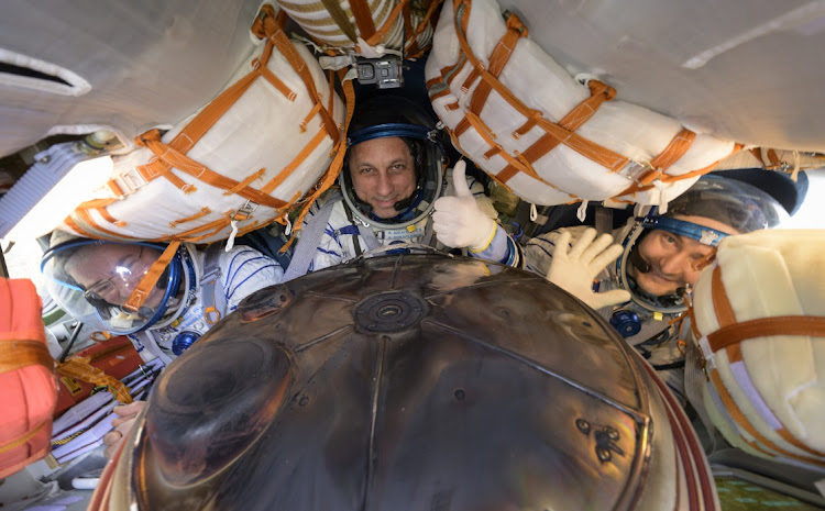 Expedition 66 crew members Mark Vande Hei of NASA, left, cosmonauts Anton Shkaplerov, center, and Pyotr Dubrov of Roscosmos, are seen inside their Soyuz MS-19 spacecraft after is landed in a remote area near the town of Zhezkazgan, Kazakhstan, Wednesday, March 30, 2022. Vande Hei and Dubrov are returning to Earth after logging 355 days in space as members of Expeditions 64-66 aboard the International Space Station. For Vande Hei, his mission is the longest single spaceflight by a US astronaut in history. Shkaplerov is returning after 176 days in space, serving as a Flight Engineer for Expedition 65 and commander of Expedition 66.
