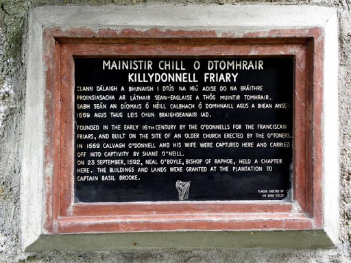 It is located at the entrance of the building. The English section of the text reads, "Founded in the early 16th Century by the O'Donnells for the Franciscan Friars, and built on the site of an...