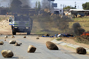 June 21, 2016. A delivery truck and a bus were set alight by angry residents of Atteridgeville, west of Pretoria. Residents brought the township to a standstill following the announcement that Parliament House Chairperson Thoko Didiza will be the mayor of Tshwane should the ANC retain the municipality later this year. Police later arrived to clean the streets while looting continued. PHOTO:PETER MOGAKI