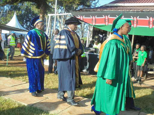 Acting VC Professor Laban Ayiro (C) with Moi University Council Chairman Professor Jenesio Kimanyario during the graduation procession on Thursday. /MATHEWS NDANYI