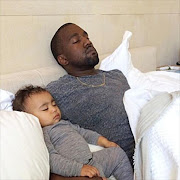 Kanye and North West sleeping.
