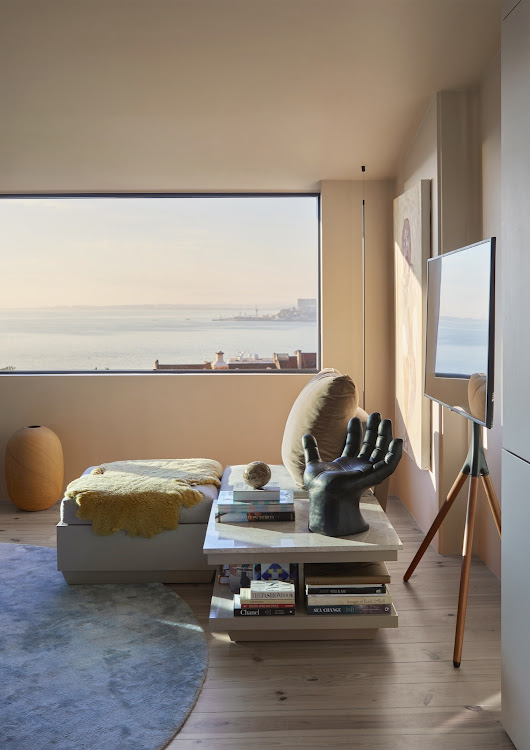 The living-room furniture is positioned to allow maximum enjoyment of the apartment’s panoramic view over central Lisbon to the Tagus. The resin hand sculpture is from a local vintage store.