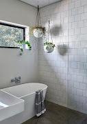 Simple square Johnson tiles - a utilitarian classic of local design - have been used in the children's bathroom.