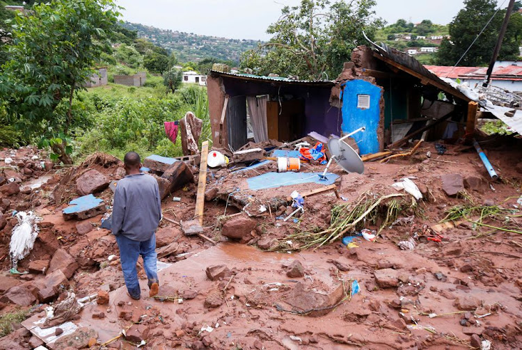 Jomba Phiri walks over where his house stood after heavy rains caused flood damage in KwaNdengezi, Durban, South Africa, April 12, 2022. REUTERS