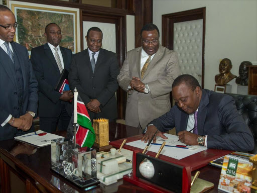 A file photo of President Uhuru Kenyatta signing a bill at State House.