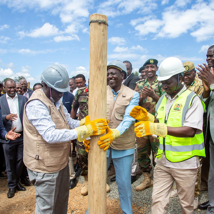 President William Ruto and Deputy President Rigathi Gachagua fix an an electricity post at the commissioning of Lariak Forest Wildlife Electric Fence, Laikipia County on April 12, 2023.