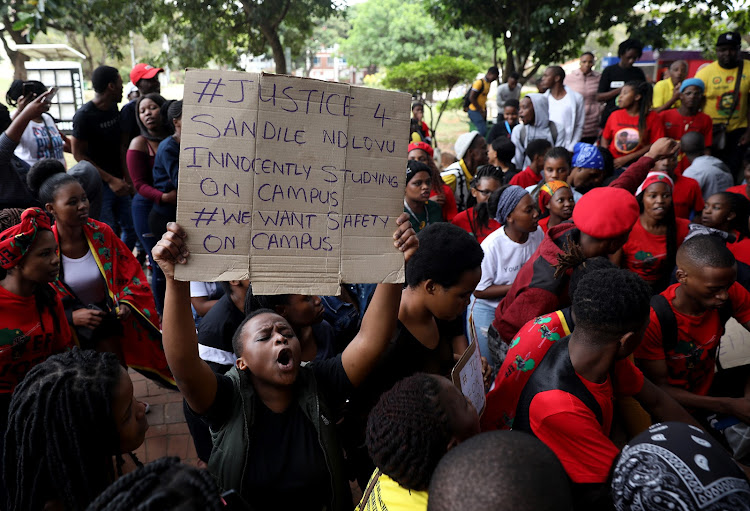 Lucy Zucula holds up a placard calling for justice for Sandile Ndlovu who was stabbed in a lecture room on Monday