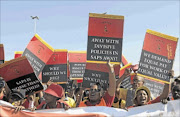 UP IN ARMS: Popcru members  who  embarked on a strike yesterday for better salaries march to the SAPS provincial head offices in Durban to hand over their memorandum Photo: TEBOGO LETSIE
