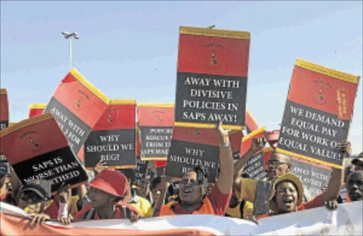 UP IN ARMS: Popcru members who embarked on a strike yesterday for better salaries march to the SAPS provincial head offices in Durban to hand over their memorandum Photo: TEBOGO LETSIE