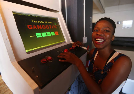 July 15, 2016 . INITIATIVE: Engineering student Regina Kgatle shows how to play her arcade game, ’The Pull of the Gangster’, at Friends of Design — Academy of Digital Arts, in Cape Town. Pic: Esa Alexander. © Sunday Times