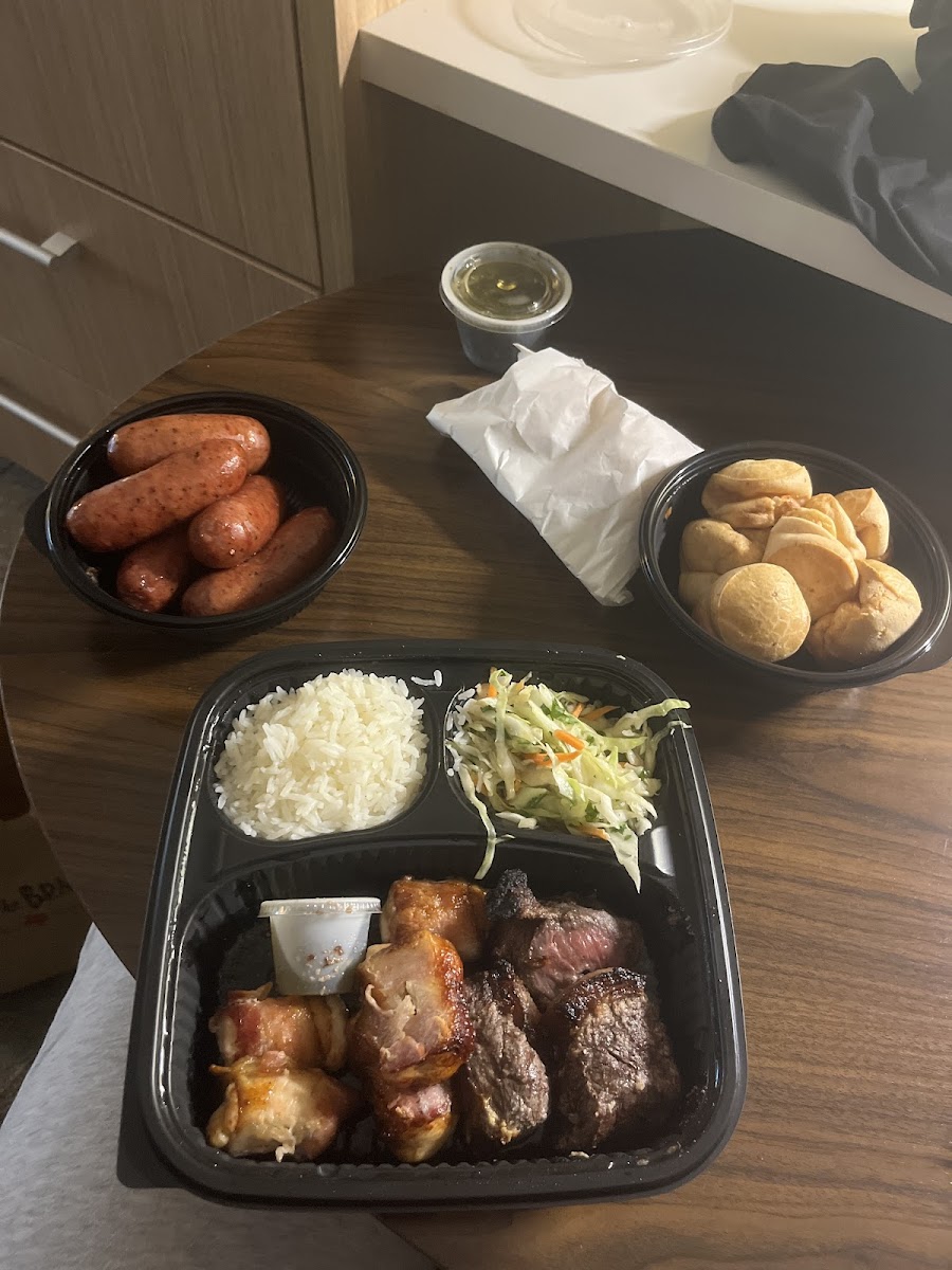 Sausage, chicken wrapped in bacon, garlic picanha, cabbage salad, jasmine rice, brazilian cheese bread, and chimichurri sauce