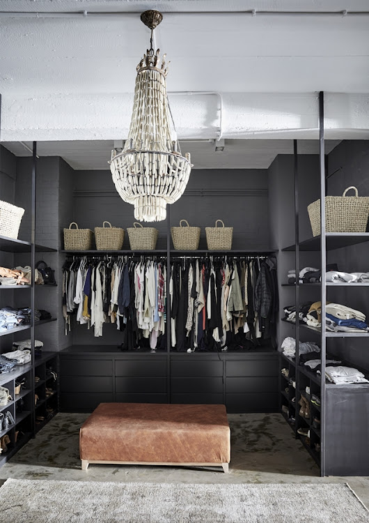 The all-black palette helps create a sense of calm and orderliness in the dressing room.