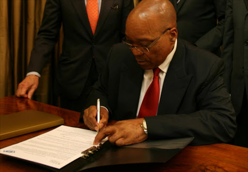 President Jacob Zuma puts his million rand signature on paper. File photo