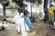 EPIDEMIC: Healthworkers at an ebola facility in Monrovia, Liberia PHOTO: ZOOM DOSSO/AFP