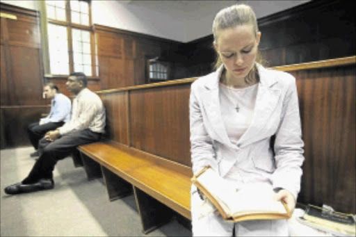 DIVINE INTERVENTION: Nicolette Lotter prays during recess in her case in the Durban High Court. She is one of three people accused of killing her parents. PHOTO: THULI DLAMINI