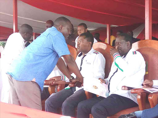 A file photo of Bondo MP Gideon Ochanda consulting NASA flag bearer Raila Odinga, who is also the ODM party leaders, during a meeting in the area. /LAMECK BARAZA