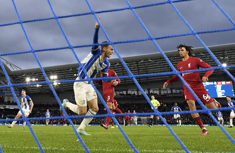 Brighton & Hove Albion's Solly March celebrates scoring their first goal as Liverpool's Trent Alexander-Arnold reacts in the Premier League match at The Community Stadium in Brighton on January 14 2023.