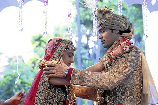 Vega Gupta, right, and Aakash Jahajgarhia at their wedding ceremony at Sun City in May 2013. Picture: SUPPLIED