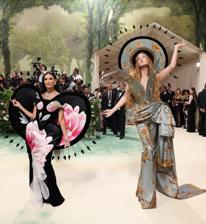 US actress Demi Moore and US-British fashion designer Harris Reed pose at the Met Gala.
