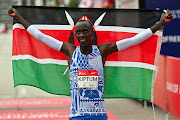 Kelvin Kiptum of Kenya celebrates after he set a new world record time of 2:00:35 at the 2023 Chicago Marathon.