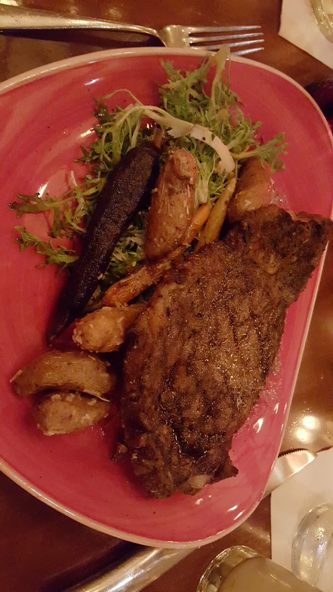 GF black Angus ribeye steaks with fingerling potatoes, multi-colored grilled carrots and Frisee toasted in a light, citrus dressing