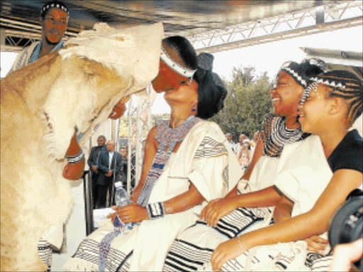 HAPPY DAYS: Newly inaugurated Thembu chief Mandla Mandela kisses his wife Thando, while cousins Phiwo and Zine Mabunu look on.