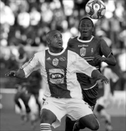 LOCKED ON: Ajax Cape Town's Salie Tawfeeq fights for the ball with Pretoria University's Thokozani Sekotlong in their Nedbank Cup semifinal match at Milpark Stadium in Johannesburg on Sunday. AmaTuks beat Ajax 2-1 in extra time. 27/04/09. Pic. Antonio Muchave. © Sowetan.