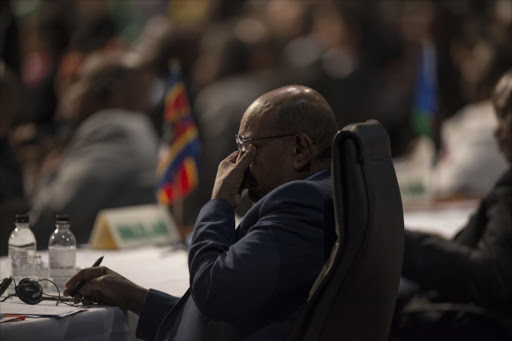 Sudanese President Omar al-Bashir wipes his eyes as he attends the opening session at the 25th African Union Summit in Sandton, Johannesburg, on June 14, 2015. File photo.