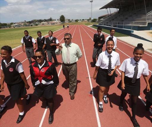 Principal Henry Alexander with pupils on their new athletics track