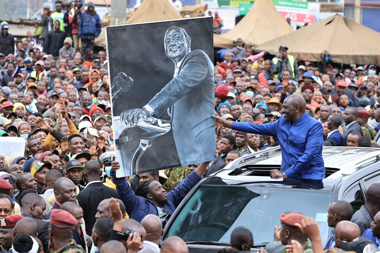 President William Ruto recieves a potrait of himself from a Kiambu artist on August 5, 2023
