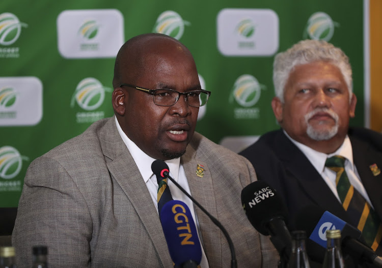 A file photo of former Cricket South Africa president Chris Nenzani (L) addressing the media on December 7 2019 in Johannesburg - a day after the suspension of chief executive Thabang Moroe - as vice-president Beresford Williams (R) listens attentively.