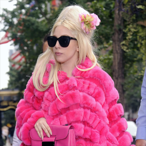 Lady Gaga in a pink fur coat.