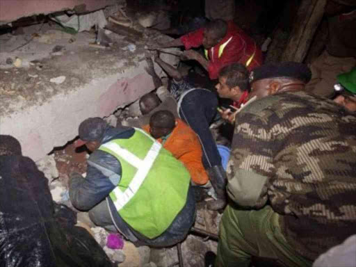 Rescuers and volunteers search for survivors at the collapsed Huruma building on May 3