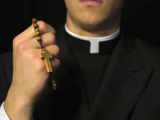 A priest holding a rosary. Photo/Courtesy