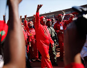 PRETORIA, SOUTH AFRICA - MAY 04:  Commander in Chief of the Economic Freedom Fighters and South African presidential candidate Julius Malema greets supporters as he enters the Lucas Moripe Stadium for an Economic Freedom Fighters presidential campaign rally at the Lucas Moripe Stadium on May 4, 2014 in Pretoria, South Africa. The rally comes prior to the South African Presidential elections which are scheduled to be held on May 7, 2014. (Photo by J. Countess/Getty Images)