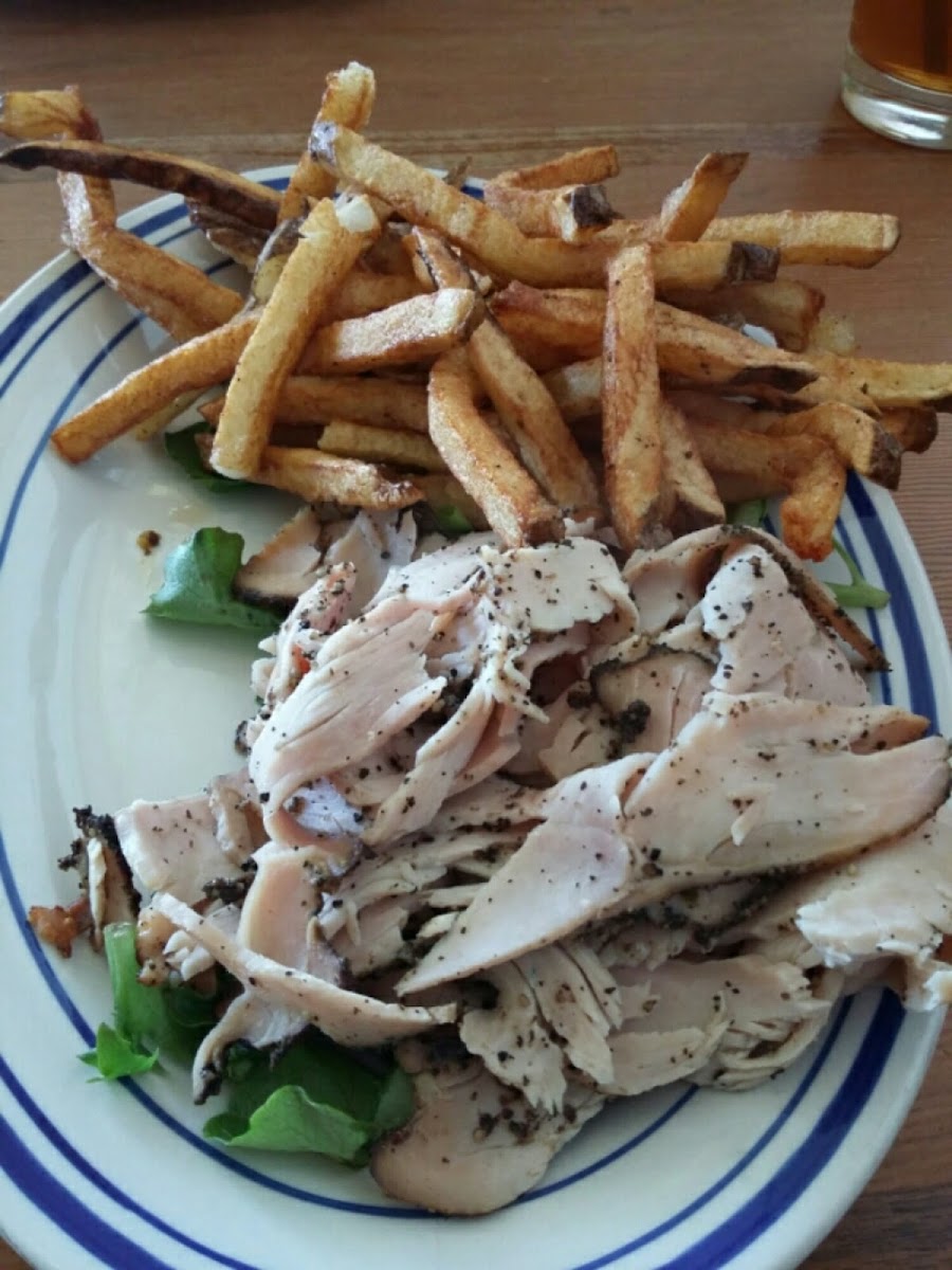 Turkey pastrami on greens with hand cut fries.