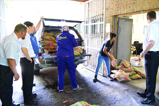 Workers offload some of the f food donated by a Greenfields retailer for the animals at the East London zoo Picture: RANDELL ROSKRUGE