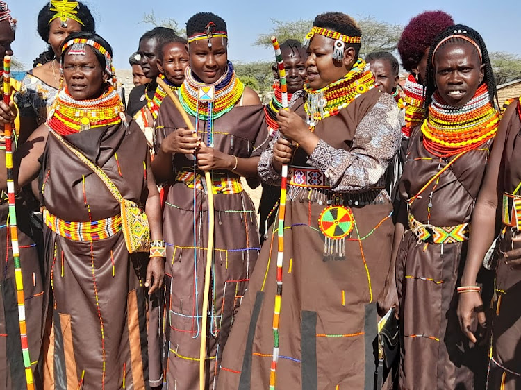Dorothy Mashipei, Coordinator for Ushanga Kenya Initiative(Second from right) dressed in Turkana regalia poses in a picture with Aberu Kori Lokichar Cooperative in Turkana South Sub County.