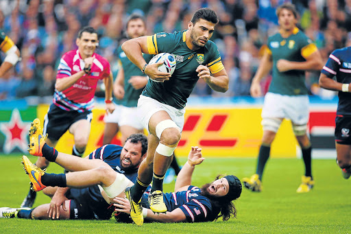 ON THE BOARD: Damian De Allende of South Africa bursts through to score their opening try during their 2015 Rugby World Cup Pool B match against the USA played at the Olympic Stadium in London, United Kingdom, yesterday Picture: GETTY IMAGES