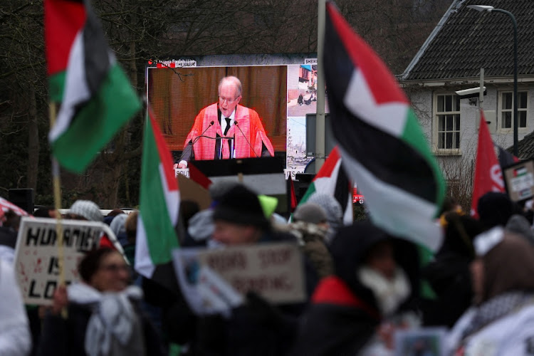 A view of a live broadcast displayed on a street as pro-Palestinian demonstrators protest near the International Court of Justice (ICJ) on the day judges hear a request for emergency measures to order Israel to stop its military actions in Gaza, in The Hague, Netherlands on Thursday