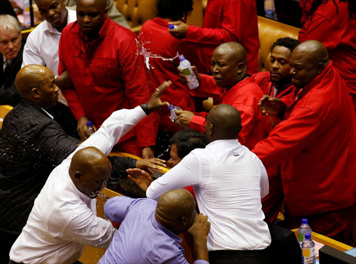 Party leader Julius Malema and members of his Economic Freedom Fighters (EFF) clash with Parliamentary security as they are evicted from the chamber in Cape Town, South Africa, May 17, 2016. REUTERS/Mike Hutchings