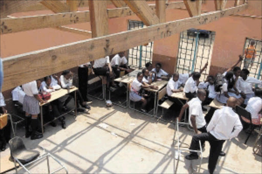 EXPOSED: Mmakaunyane High School pupils in North West sit in one of the classes of which the roofing was stolen by thieves during the December holidays. PHOTO: Peggy Nkomo. 13/01/2010. © Sowetan.