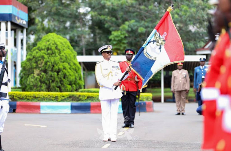 Chief of Defence Forces (CDF) General Charles Kahariri holding the KDF Flag during a change of guard at the DoD in Nairobi on May 7, 2024.
