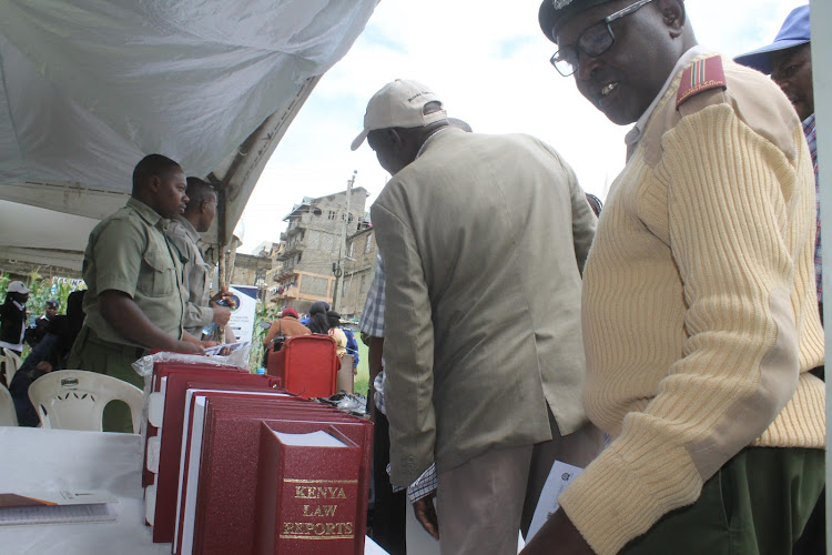 Mlolongo chief Peter Ndunda joins a queue as he seeks information from various court users' institutions during the Mavoko Law Courts Open Day in Mlolongo, Machakos County on April 26, 2024.