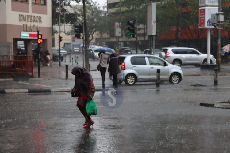 Nairobi residents brave heavy evening rainfall on March 23, 2023 .