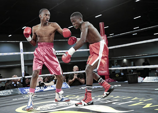 Ricardo Malajika, left, pummels Nkululeko Mnisi.